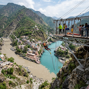 Person jumping from a bungee platform over two rivers meeting